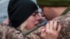 A Ukrainian soldier says goodbye to his wife after a short break from his frontline duties at the train station in Kramatorsk on February 14.