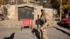 A fighter walks outside the Turkish Embassy after fighters of the ruling Syrian body ousted Syria's Bashar al-Assad, in Damascus on December 14. 