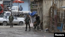 Government soldiers patrol in Ain Tarma, near Damascus