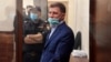 Khabarovsk Governor Sergei Furgal stands inside a defendants' cage during a court hearing in Moscow on July 10. 