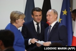 Angela Merkel (left to right), Emmanuel Macron, and Vladimir Putin speak at the Elysee Palace in Paris after a summit on Ukraine in December 2019.