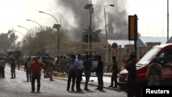 Smoke rises from the site of a bomb attack in Baghdad on March 14.