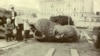 A broken bronze head from a statue of Tsar Alexander III lies discarded on a street in Moscow.