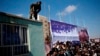 A security guard keeps watch during a rally by Afghan presidential candidate Zalmai Rasul in Mazar-e Shariff on March 27.