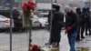 People in central Saint Petersburg lay flowers at a makeshift memorial to the victims of a shooting incident at a concert hall outside Moscow the previous day. 