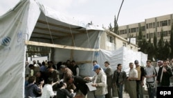 Iraqi refugees line up at a UNHCR registration center in Syria