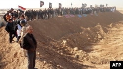 Demonstrators protest outside Camp Ashraf, home to exiled Iranian opposition members, in Iraq's Diyala province on December 9.