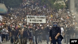 Protesters face off against police near the parliament building in the center of Athens on May 5.