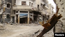 Damaged buildings in the old city of Homs on March 30