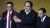 The president of Afghanistan's soccer federation, Karim Keramuddin (center), holds up the 2013 FIFA Fair Play Award in Zurich on January 13. 