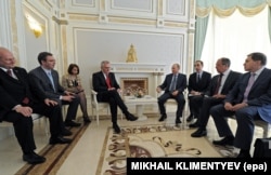 Dmitry Iordanidi (third from right) setting between Russian President Vladimir Putin and Foreign Minister Sergei Lavrov (second from right) at a May 2013 meeting with Serbia's then-president, Tomislav Nikolic (fourth from left) at a state residence in the Black Sea resort of Sochi, Russia.