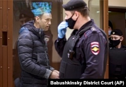 Russian opposition leader Aleksei Navalny inside a glass cage during a hearing on charges of defamation in a Moscow court on February 12