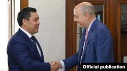 RFE/RL President Jamie Fly (right) meets with Kyrgyz President Sadyr Japarov in Bishkek in September 2021.