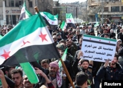 Syrians demonstrate in support of the Syrian government in Aleppo on March 7.