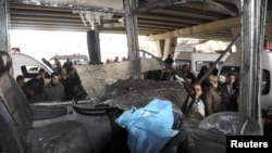 A damaged bus after an explosion in the Maidan district of Damascus on January 6 that killed at least 26 people.