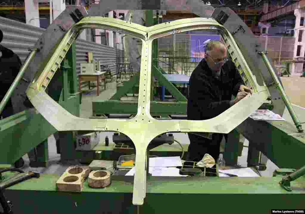 The distinctive cockpit window frame of the Superjet being assembled. The Russian government would eventually fund some 25% of the reported $1.4 billion spent on development of the jet, intended primarily for use as a regional passenger plane.