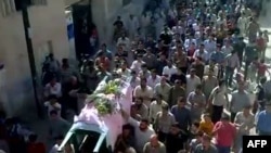 An image grab from a video uploaded on YouTube reportedly shows the funeral of antigovernment demonstrator Ahmad Ibrahim outside Hama on October 10.