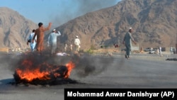 Men shout slogans against the attackers after a deadly suicide blast in Nangarhar Province on September 11.