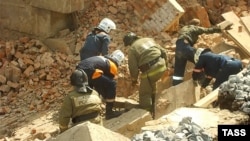 Rescuers search for survivors after a wall collapsed during the reconstruction of a building in Novosibirsk.