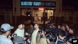 Relatives of passengers of a train, which was attacked by insurgents, gather to get information about passengers at a railway station in Quetta, Pakistan, on March 11, 2025. 