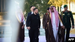 In this handout photograph taken and released by the Ukrainian Presidential Press Service on March 10, 2025, Ukraine's President Volodymyr Zelensky (C-L) is welcomed by Saudi deputy Mecca Governor Prince Badr bin Sultan bin Abdulaziz (C-R) upon his arriva