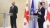 European Council President Charles Michel (left) last week called on Prime Minister Irakli Gharibashvili (right) and the country's political parties to engage in dialogue to defuse the "worsening crisis."