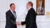 Russian Foreign Minister Sergei Lavrov (left) shakes hands with Azerbaijani President Ilham Aliyev ahead of a meeting in Baku on November 19.