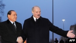 Belarusian President Alyaksandr Lukashenka (right) welcomes Italian Prime Minister Silvio Berlusconi to Minsk.