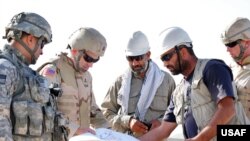 U.S. and Afghan engineers review blueprints for a construction project in Farah Province. U.S. Undersecretary of Defense Michele Flournoy recently said that that U.S. "troops can do astonishing things with even minimal resources, but they can't do magic."