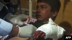 An injured student receives treatment at a Peshawar hospital following the attack.