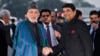 Afghan President Hamid Karzai (left) shakes hands with Indian Minister of State for Home Affairs R.P.N Singh on his arrival in New Delhi on December 12.