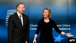 EU foreign-policy chief Federica Mogherini (right) welcomes Azerbaijani President Ilham Aliyev prior to their bilateral meeting at EU headquarters in Brussels on February 6.