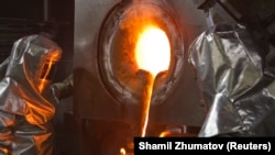 Workers wearing heatproof overalls pour molten gold from a crucible into molds in a workshop at the Kumtor gold mine in the Tien Shan mountains, some 350 kilometers southeast of the capital, Bishkek. 